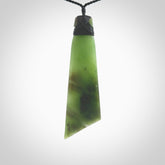 Hand carved large Toki pendant from a lovely piece of local New Zealand Jade. The quality of the workmanship and design is outstanding - this is a piece you will want to wear all the time. We have suspended this from a 4-plait black cord which can be adjusted with a couple of slip knots and black binding.